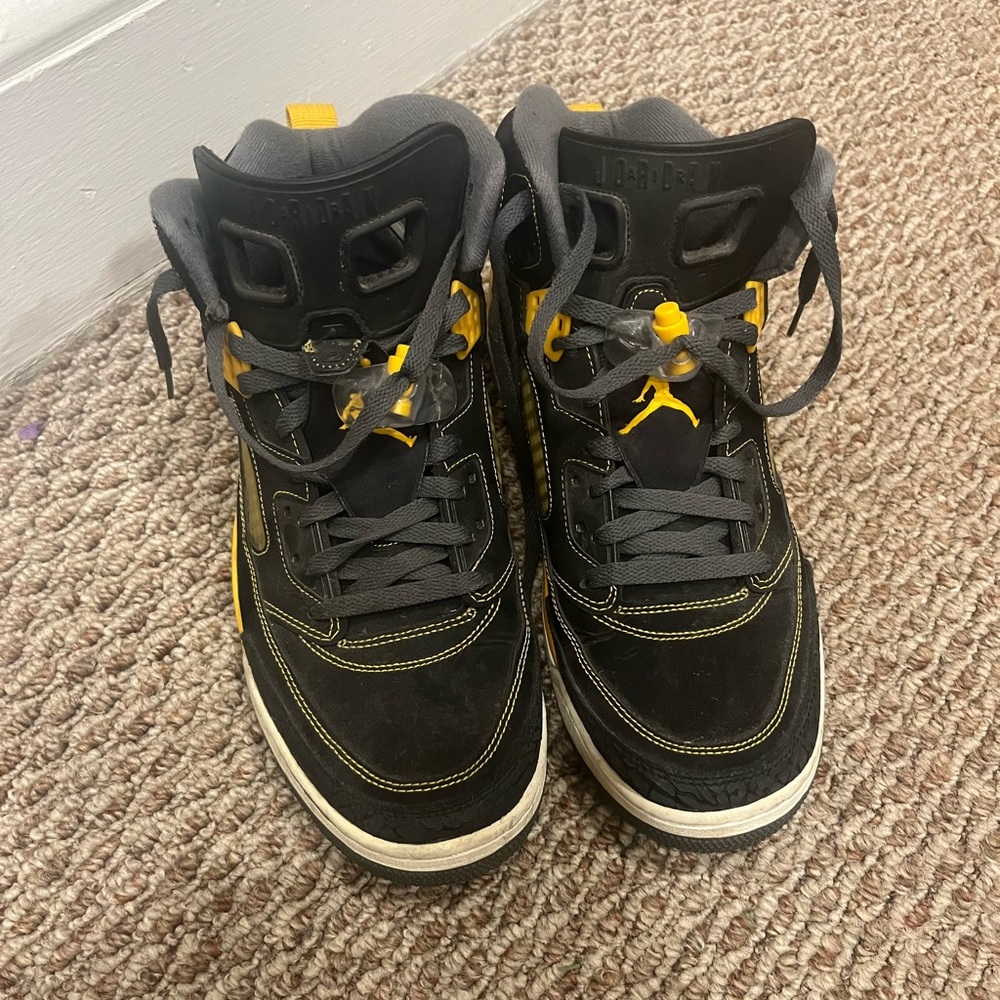 Nike black and yellow Jordan’s